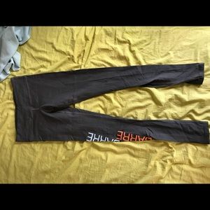 Pure Barre grey, orange, and blue leggings